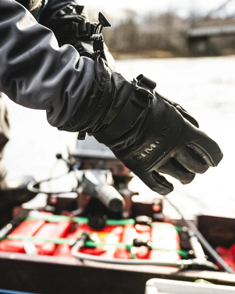 Load image into Gallery viewer, Simms insulated black glove on hand with wrist strap and pull tab
