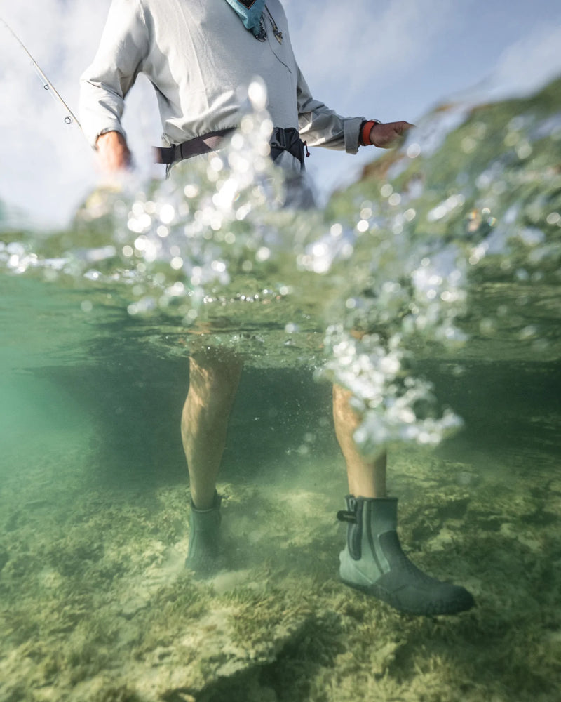 Load image into Gallery viewer, Dark gray zippered booties worn underwater, hex tread visible on soles
