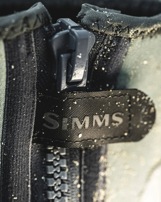 Side zipper and SIMMS logo patch on dark gray bootie, wet finish