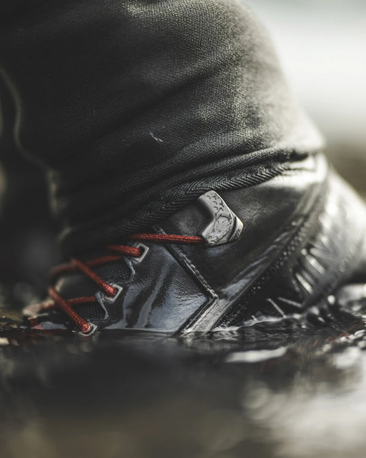 Simms felt boot close-up: gray upper, orange laces, textured side detail