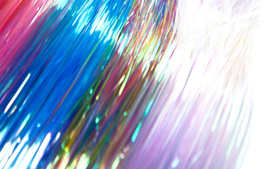 Iridescent glossy pearl fringe strands close-up with blue, purple, and green sheen