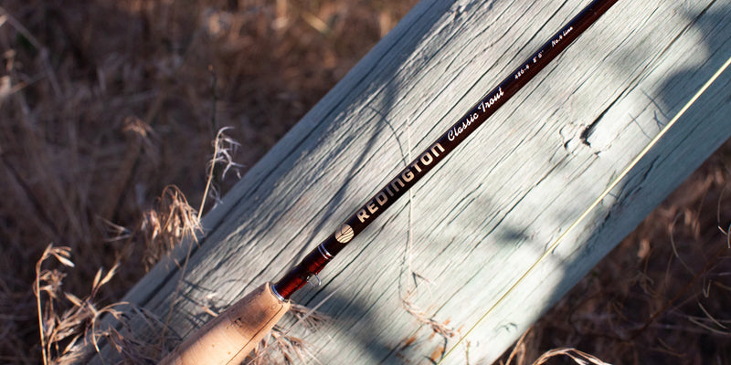 Load image into Gallery viewer, Fishing rod close-up: Redington Classic Trout label on dark blank
