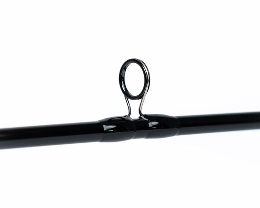 Black fishing rod with metal line guide ring near the middle