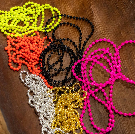 Bead chain eye accessory with multiple round-bead strands in green, orange, black, and pink