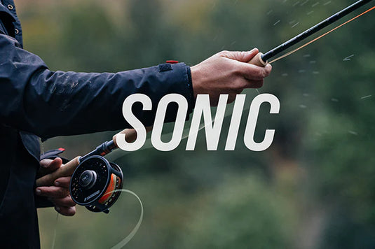 Fishing rod with cork handle and spinning reel, held while casting