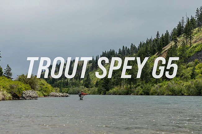 Load image into Gallery viewer, Spey fishing rod with cork grip, held above a river.

