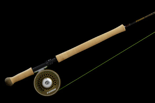 Spey fishing rod with cork grips and mounted fly reel on a dark reel seat.