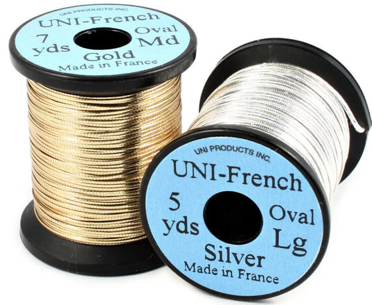Oval tinsel thread spools, gold and silver metallic ribbon on black reels