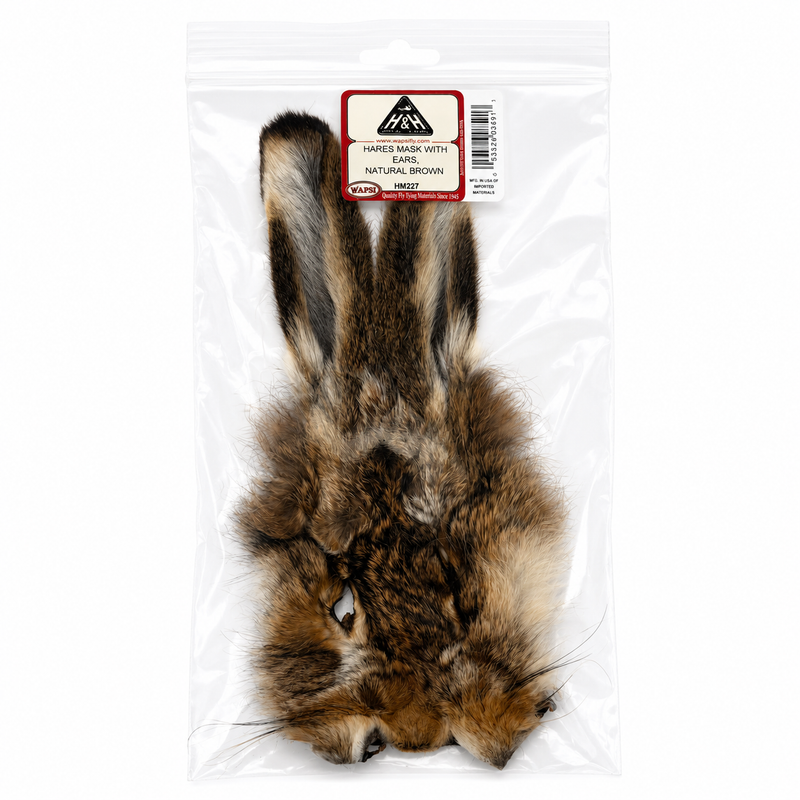 Load image into Gallery viewer, Hares mask with mottled brown, black and cream fur, two upright ears, in plastic bag
