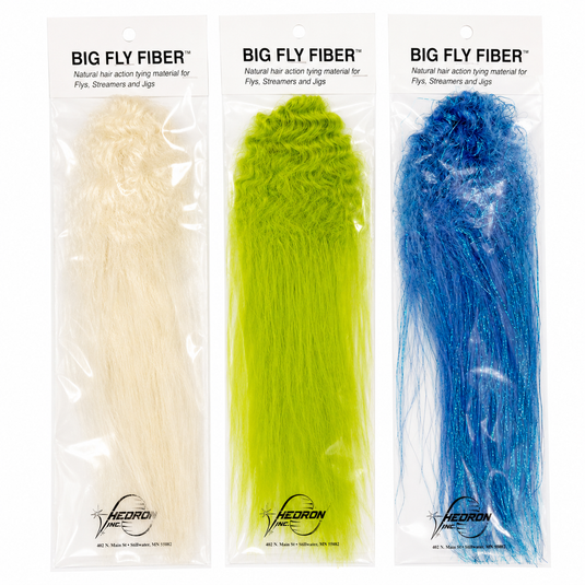 Curled fly-tying fibre in sealed pack, white, green, and blue strands.