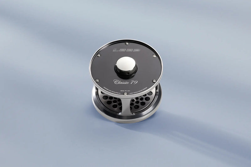 Load image into Gallery viewer, Loop Classic Series reel with dark face, engraved badge, and center knob
