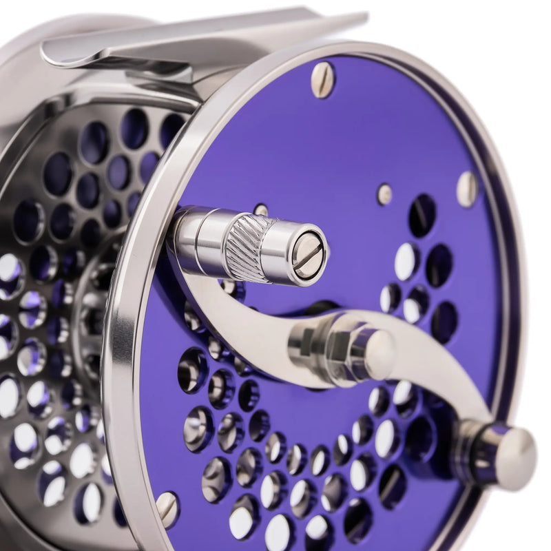 Load image into Gallery viewer, Purple fishing reel with metal handle and perforated spool face
