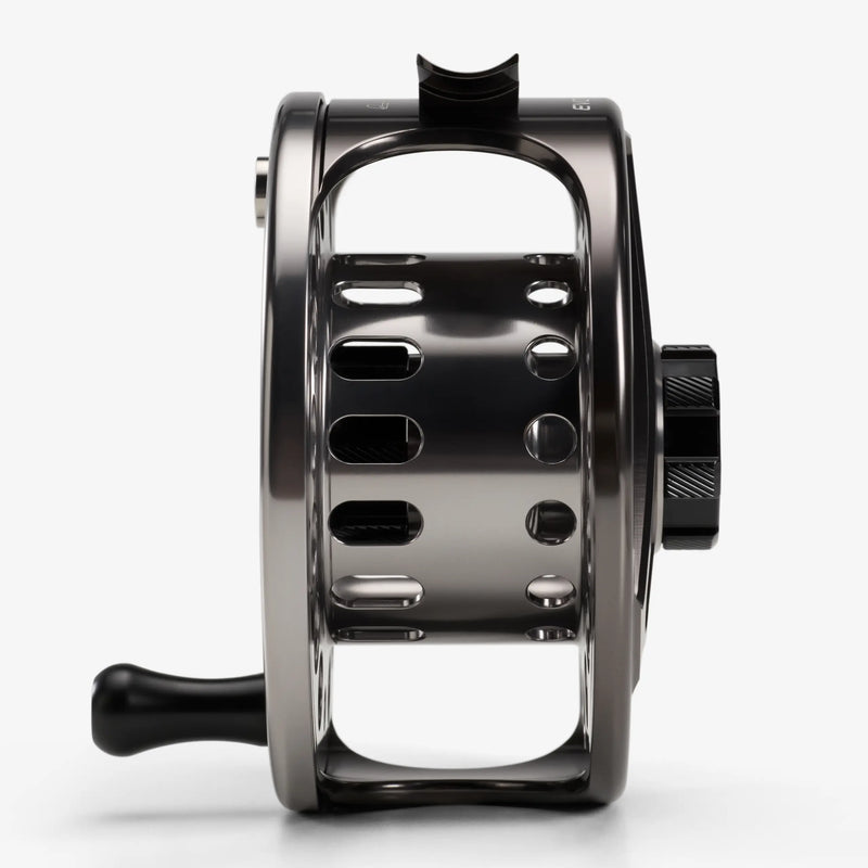 Load image into Gallery viewer, Black fly fishing reel side view with arched frame and star handle knob
