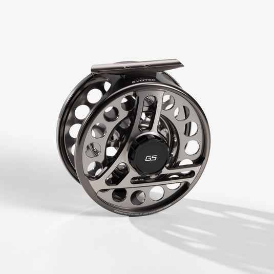 Black and silver fly fishing reel with perforated rim and G5 center badge