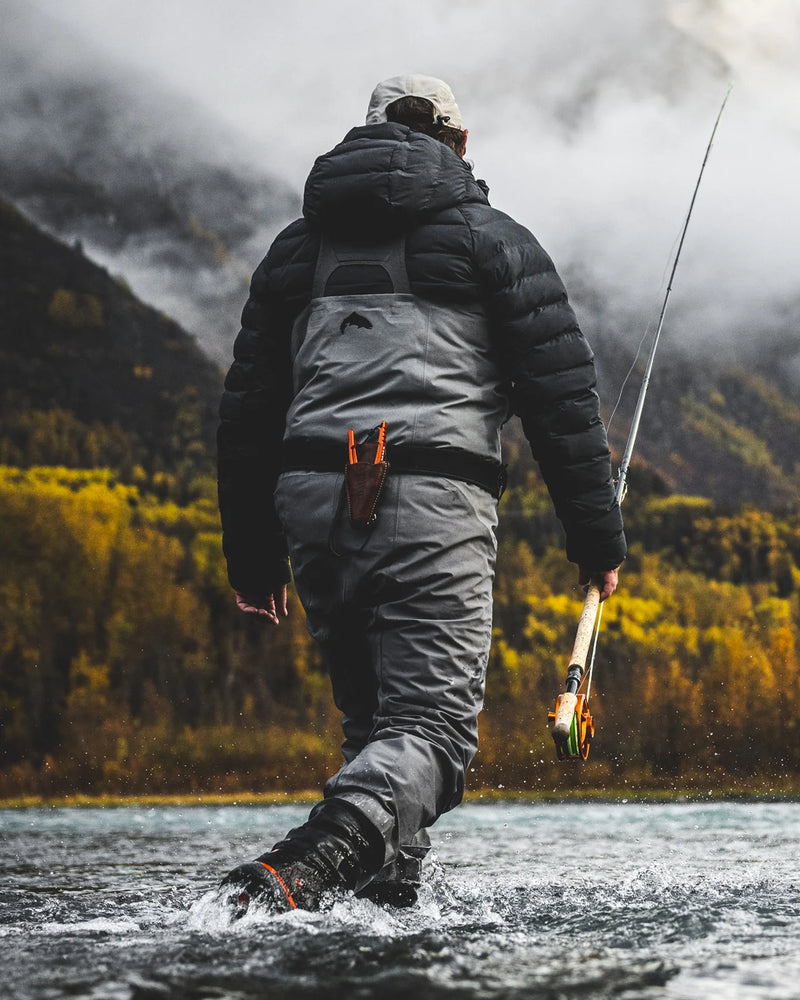 Load image into Gallery viewer, Guide pliers in a brown leather sheath on a person’s dark jacket while fishing
