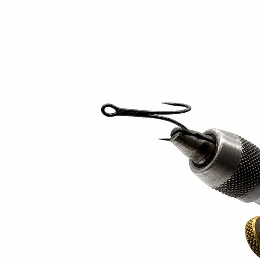 Barbed fishing hook attached to metal needle tool