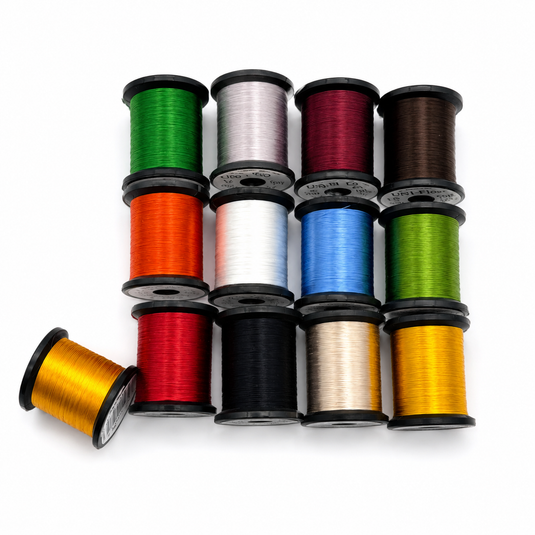 Uni-Floss embroidery floss spools in mixed colors: green, silver, burgundy, brown, orange, yellow.
