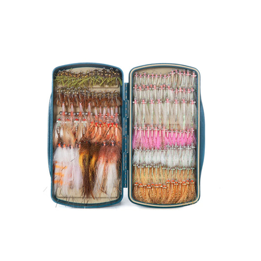 Teal fly box open with two compartments and assorted fly patterns on foam inserts