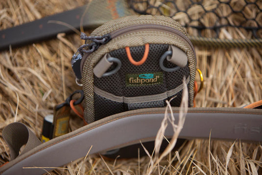 Fishpond San Juan vertical chest pack with fishpond logo, brown mesh front pouch and cords
